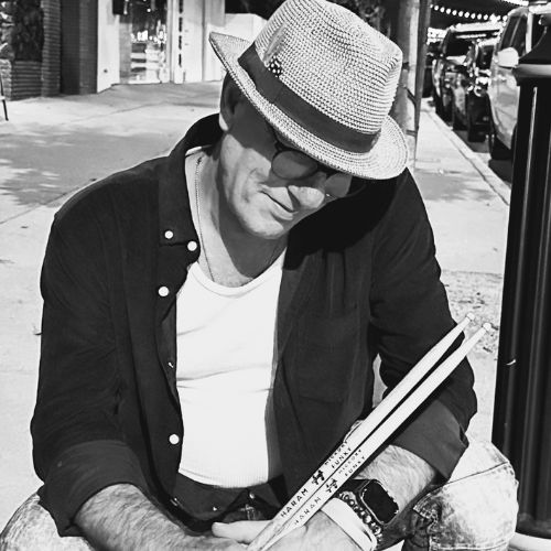 professional-drummer-Darren-Elliott-holding-a-pair-of-Haram-drumsticks